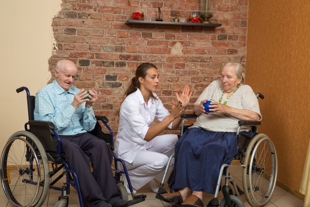 Two Senior In Wheelchairs During Physiotherapy