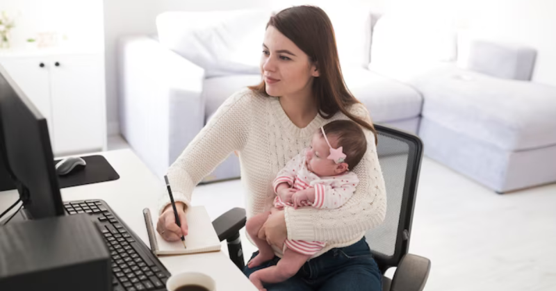 woman-writing-holding-baby